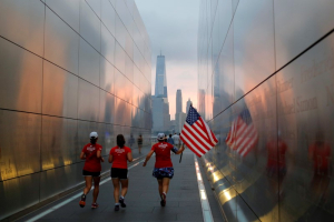 People run through the Empty Sky memorial at daybreak over lower Manhattan on the morning of the 15th anniversary of the 9/11 attacks, in New Jersey, U.S., September 11, 2016.  REUTERS/Andrew Kelly <br/>