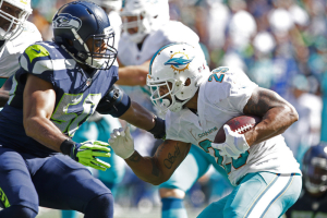 Miami Dolphins running back Arian Foster (29) breaks a tackle by Seattle Seahawks outside linebacker K.J. Wright (50) during the second quarter at CenturyLink Field.  <br/>Joe Nicholson-USA TODAY Sports