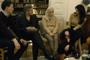 IRC President and CEO David Miliband (L) George Clooney (2nd L), and Amal Clooney (R) meet with Syrian refugees Mona and her daughter, 11-year-old Joudi, in Berlin, Germany February 12, 2016 in this handout provided by the International Rescue Committee (IRC) February 13,... REUTERS/Jeffry Ruigendijk/International Rescue Committee/Handout via Reuters <br/>