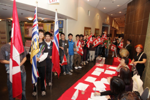 Chinese-Canadian youths holding Canadian flags while waiting to march into the main stage during the opening of CASJAFVA's fundraising dinner. <br/>Jacky Ko