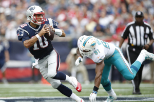 New England Patriots quarterback Jimmy Garoppolo (10) is forced out of the pocket by Miami Dolphins defensive end Cameron Wake (91) during the second quarter at Gillette Stadium.  <br/>Greg M. Cooper-USA TODAY Sports