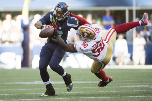 Seattle Seahawks quarterback Russell Wilson (3) is tackled by San Francisco 49ers outside linebacker Eli Harold (58) during the third quarter at CenturyLink Field. Wilson was injured on the play. The Seahawks won 37-18.  <br/>Troy Wayrynen-USA TODAY Sports