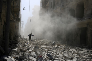 A man walks on the rubble of damaged buildings after an airstrike on the rebel held al-Qaterji neighbourhood of Aleppo, Syria September 25, 2016. REUTERS/Abdalrhman Ismail <br/>