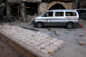 An ambulance is parked next to stacks of bread at a damaged site after an airstrike in the rebel-held Bab al-Maqam neighbourhood of Aleppo, Syria, September 28, 2016. REUTERS/Abdalrhman Ismail <br/>