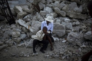 A woman and a youth attend mass next to the rubble of the Notre Dame Cathedral in Port-au-Prince, Haiti, Sunday Nov. 14, 2010. <br/>AP Images / Emilio Morenatti