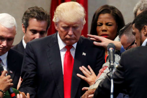 Members of the clergy lay hands and pray over Republican presidential nominee Donald Trump at the New Spirit Revival Center in Cleveland Heights, Ohio, U.S., September 21, 2016. (Jonathan Ernst/Reuters) <br/>