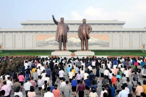 Two South Korean Christian pastors have been arrested in China for allegedly helping to smuggle North Korean defectors out of the country. Service personnel and civilians lay floral baskets, bouquets and flowers before the statues of President Kim Il Sung and leader Kim Jong Il on the 68th founding anniversary of the DPRK in this undated photo released by North Korea's Korean Central News Agency (KCNA). <br/>Reuters 