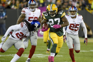 Green Bay Packers running back Eddie Lacy (27) breaks free for a first down against New York Giants cornerback Janoris Jenkins (20) and cornerback Leon Hall (25) in the second quarter at Lambeau Field.  <br/>Benny Sieu-USA TODAY Sports