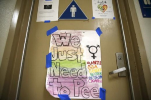 A protest sign on a bathroom which helped lobby for the first gender-neutral restroom in the Los Angeles school district is seen at Santee Education Complex high school in Los Angeles, California, U.S., April 18, 2016.<br />
<br />
 <br/>Reuters/Lucy Nicholson