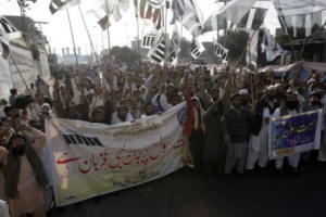 Supporters of Pakistani militant group Jamaat-e-Dawa rally against Asia Bibi in Lahore, Pakistan. Banner on left reads <br/>AP