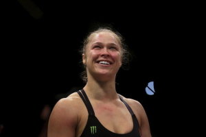Ronda Rousey (R) of U.S celebrates after defeating Bethe Correia of Brazil during their Ultimate Fighting Championship (UFC) match, a professional mixed martial arts (MMA) competition in Rio de Janeiro, Brazil August 1, 2015.  <br/>REUTERS/Ricardo Moraes