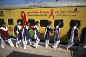 Indian students enter The Red Ribbon Express train in Jammu, India, Saturday, Nov. 13, 2010. The Red Ribbon Express train is on a countrywide tour to spread awareness on HIV/AIDS and to promote safe behavioral practices. <br/>AP Images / Channi Anand