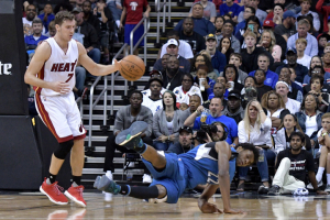 Minnesota Timberwolves forward Andrew Wiggins (22) is tripped up by Miami Heat guard Goran Dragic (7) during the second half at Sprint Center. Minnesota won 109 - 100.  <br/>Denny Medley-USA TODAY Sports
