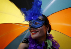 A reveller carrying an umbrella takes part in a LGBT (lesbian, gay, bisexual, andtransgender) pride parade to mark Gaijatra Festival, also known as the festival of cows, in Kathmandu, Nepal.<br />
<br />
 <br/>Reuters/ Navesh Chitrakar