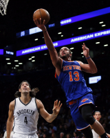 New York Knicks center Joakim Noah (13) drives to the basket against Brooklyn Nets forward Luis Scola (4) at Barclays Center.  <br/>Noah K. Murray-USA TODAY Sports