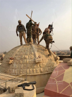 The Iraqi Army raising the cross again on the top of Mart Barbara monastery in Karemlash after liberating the village. <br/> Al-Mawsleya 
