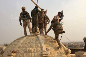 The Iraqi Army raising the cross again on the top of Mart Barbara monastery in Karemlash after liberating the village. <br/> Al-Mawsleya 