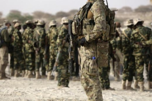 A U.S. special forces soldier stands in front of Chadian soldiers during Flintlock 2015, an American-led military exercise, in Mao. <br/>Reuters