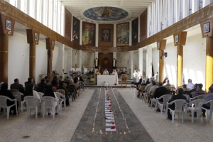 In this file photo, Iraqi Christians pray during a mass at Our Lady of Salvation church in Baghdad, Iraq, Sunday Nov. 28, 2010. Iraq has arrested at least 12 suspected al-Qaida insurgents believed to be behind a deadly Baghdad church siege a month ago. <br/>AP Images / Karim Kadim