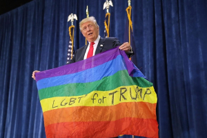 Republican presidential nominee Donald Trump holds a gay flag <br/>Getty Images