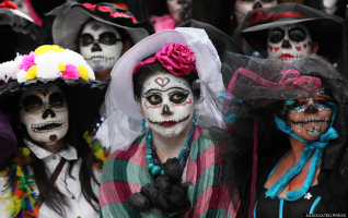 Women celebrating Day of the Dead, donning Catrina-styled faces and clothing.  <br/>google.com/
