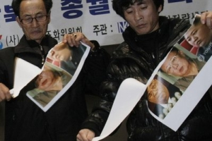 Unidentified former North Korean defectors tear photos of North Korean leader Kim Jong Il, his late father Kim Il Sung and his youngest son Kim Jong Un during a rally denouncing North Korea's Nov. 23 bombardment on a South Korean border island, in Seoul, South Korea, Thursday, Dec. 9, 2010. Two weeks after North Korea shelled a South Korean island, the rivals are still trading threats. Tensions remain at their highest in more than a decade, and though neither side is backing down, all-out war is unlikely. <br/>AP/Ahn Young-joon