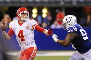 Kansas City Chiefs quarterback Nick Foles (4) tries to avoid Indianapolis Colts tackle Zach Kerr (94) at Lucas Oil Stadium.  <br/>Mandatory Credit: Thomas J. Russo-USA TODAY Sports