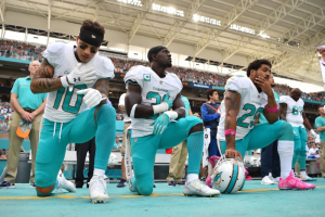 From left Miami Dolphins wide receiver Kenny Stills (10), free safety Michael Thomas (31) and Miami Dolphins defensive back Arian Foster (29) kneel during the National Anthem before the game against the Pittsburgh Steelers at Hard Rock Stadium.  <br/>Mandatory Credit: Jasen Vinlove-USA TODAY Sports