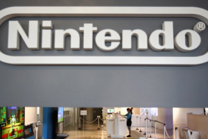 A staff of Nintendo Co Ltd showroom working is seen under its logo at its showroom in Tokyo January 29, 2014. REUTERS/Yuya Shino <br/>
