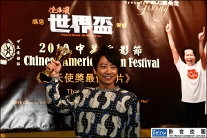 Eric Suen, who starred as Wai-Tung Ng, poses before the poster of the movie. <br/>Media Evangelism Hong Kong 