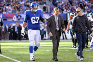  New York Giants guard Justin Pugh (67) is helped off the field after spraining a knee during the second quarter against the Philadelphia Eagles at MetLife Stadium.  <br/>Mandatory Credit: Brad Penner-USA TODAY Sports