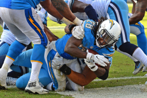 San Diego Chargers running back Melvin Gordon (28) scores a touchdown as Tennessee Titans nose tackle Al Woods (96) defends during the third quarter at Qualcomm Stadium.  <br/>Mandatory Credit: Jake Roth-USA TODAY Sports