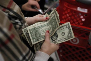 A customer counts her money while waiting in line to check out at a Target store in Torrington, Connecticut November 25, 2011<br />
<br />
 <br/>Reuters/Jessica Rinaldi 