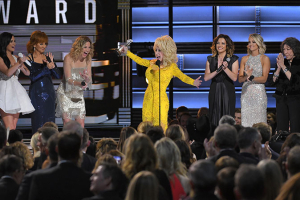 Dolly Parton accepts the Lifetime Achievement Award as singers Kacey Musgraves (L to R), Reba McEntire, Jennifer Nettles, Martina McBride, Carrie Underwood and actress Lily Tomlin applaud at the 50th Annual Country Music Association Awards in Nashville, Tennessee. REUTERS/Harrison McClary <br/>