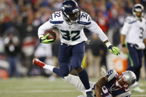 Seattle Seahawks running back Christine Michael (32) escapes from New England Patriots cornerback Malcolm Butler (21) during the fourth quarter at Gillette Stadium. The Seattle Seahawks won 31-24.  <br/>Mandatory Credit: Greg M. Cooper-USA TODAY Sports