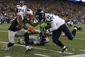 Seattle Seahawks running back Christine Michael (32) is stopped by New England Patriots strong safety Patrick Chung (23) during the second quarter at Gillette Stadium.  <br/>Greg M. Cooper-USA TODAY Sports