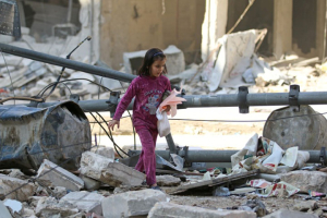 A girl makes her way through the debris of a damaged site that was hit yesterday by airstrikes in the rebel held al-Shaar neighbourhood of Aleppo, Syria November 17, 2016. REUTERS/Abdalrhman Ismail <br/>