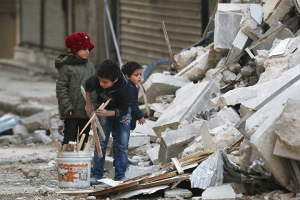 Children collect firewood amid damage and debris at a site hit yesterday by airstrikes in the rebel held al-Shaar neighbourhood of Aleppo, Syria November 17, 2016. REUTERS/Abdalrhman Ismail <br/>
