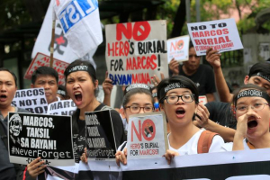 Protesters shout anti-Marcos slogans denouncing the burial of former Philippine dictator Ferdinand Marcos at the Libingan ng mga Bayani (heroes' cemetery), along a main street in Taft avenue, metro Manila, Philippines November 18, 2016. <br />
<br />
 <br/>Reuters/Romeo Ranoco