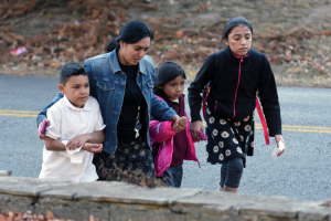 A woman escorted three children away from the scene of a school bus crash that killed at least five children.  <br/>Angela Lewis/Reuters