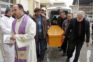 Mourners carry the coffin of slain Christian Fawzi Rahim, 76, during his funeral Mass at St. George Chaldean Church in Baghdad, Iraq, Friday, Dec. 31, 2010. <br/> AP Images / Khalid Mohammed
