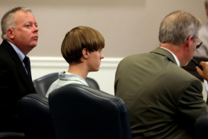 A judge ruled Friday, Nov. 25, 2016, that Dylann Roof (shown in middle), is competent to stand trial for the killing of nine black worshippers at a South Carolina church. As of Nov. 28, Roof is acting as his own attorney.  <br/>KGOU