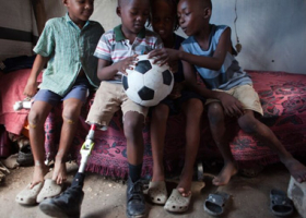 Sebastian and his friends admire the new football given to them by cbm <br/>CBM/Shelley