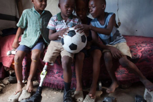 Sebastian and his friends admire the new football given to them by cbm <br/>CBM/Shelley