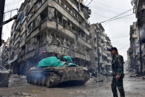Syrian pro-government forces moved through the Jisr al-Haj neighborhood on Wednesday. <br/>AFP/ Getty Images. 