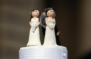 Two bride figurines adorn the top of a wedding cake during an illegal same-sex wedding ceremony in central Melbourne.<br />
<br />
 <br/>Reuters/Mick Tsikas 