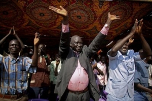 Southern Sudanese react to the announcement of preliminary referendum results in the southern capital of Juba, Sunday, Jan. 30, 2011. Referendum officials indicated that nearly 99 percent of all voters cast ballots in favor of southern independence. Southern Sudan will remained united with the north until the expiration of Comprehensive Peace Agreement in July 2011 at which point it is set to emerge as a separate state. <br/>AP/Pete Muller