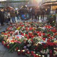A makeshift memorial for the victims of the Berlin Christmas market attack is filled with flowers and candles brought by mourners.  <br/>Twitter/ FranklinGraham