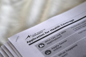 The federal government forms for applying for health coverage are seen at a rally held by supporters of the Affordable Care Act. <br />
<br />
 <br/>Reuters/Jonathan Bachman 