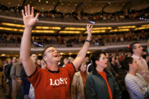 A parishioner cries as he signs a song of worship in the7,000-seat Willow Creek Community church during a Sunday service in South Barrington, Illinois, November 20, 2005.<br />
<br />
 <br/>Reuters